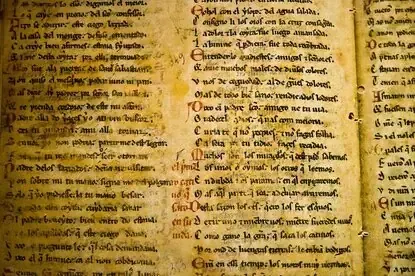 A page of a medieval manuscript written in columns of black and red script